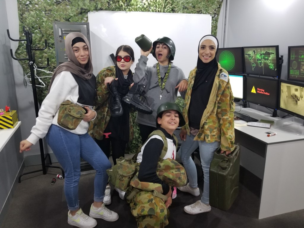 Teenagers playing an army themed escape room