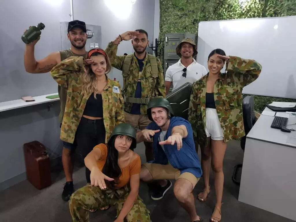 Team salute celebrating their success in the Launch escape room.