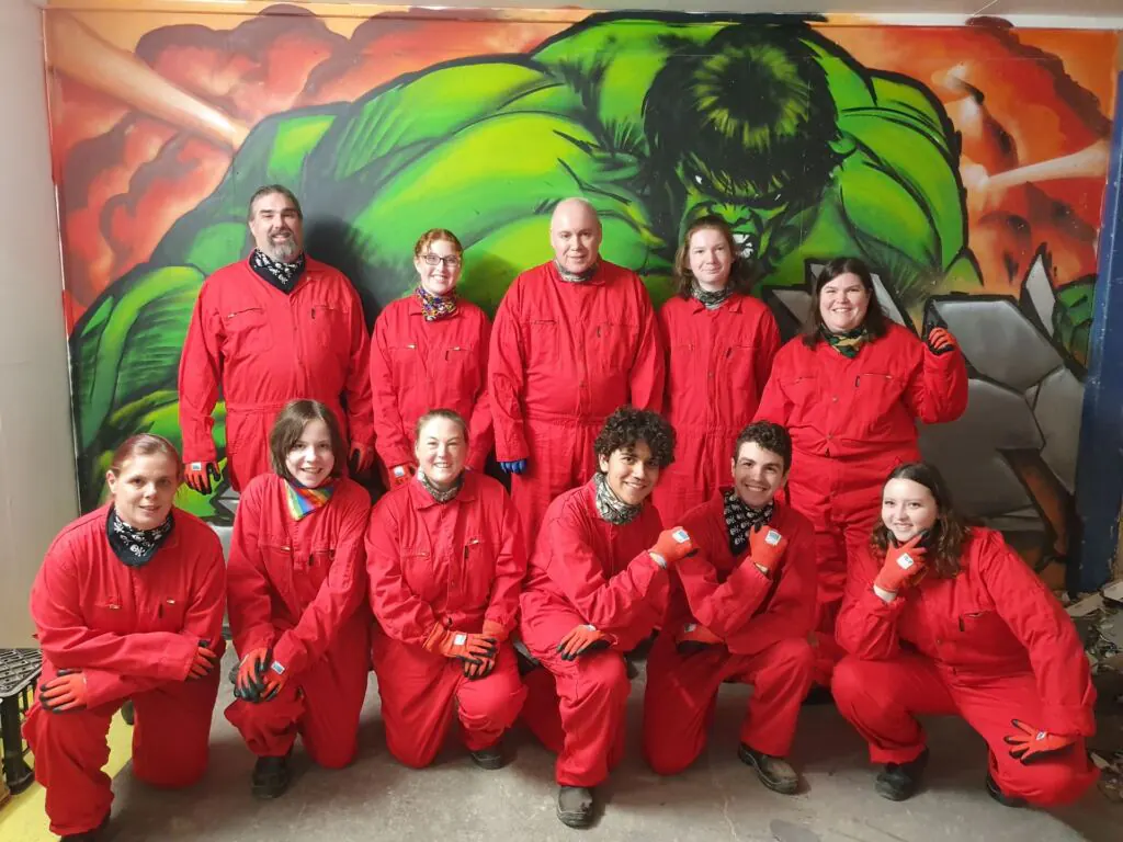 The Narrow Escape Rooms team dressed in red overalls at Smash Stuff